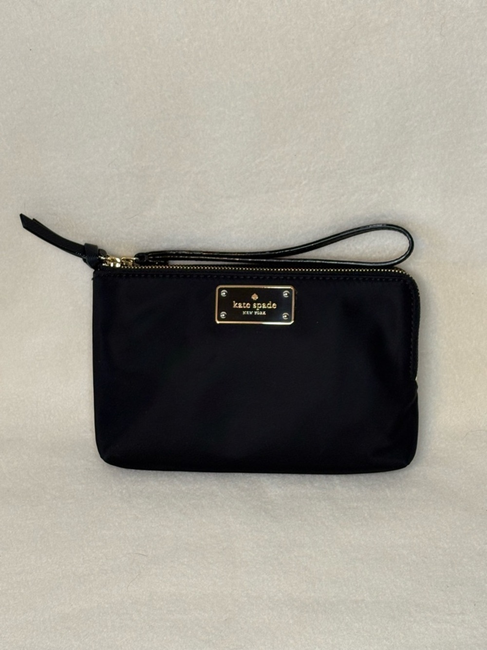 NWT Kate Spade black nylon wristlet with gold plaque